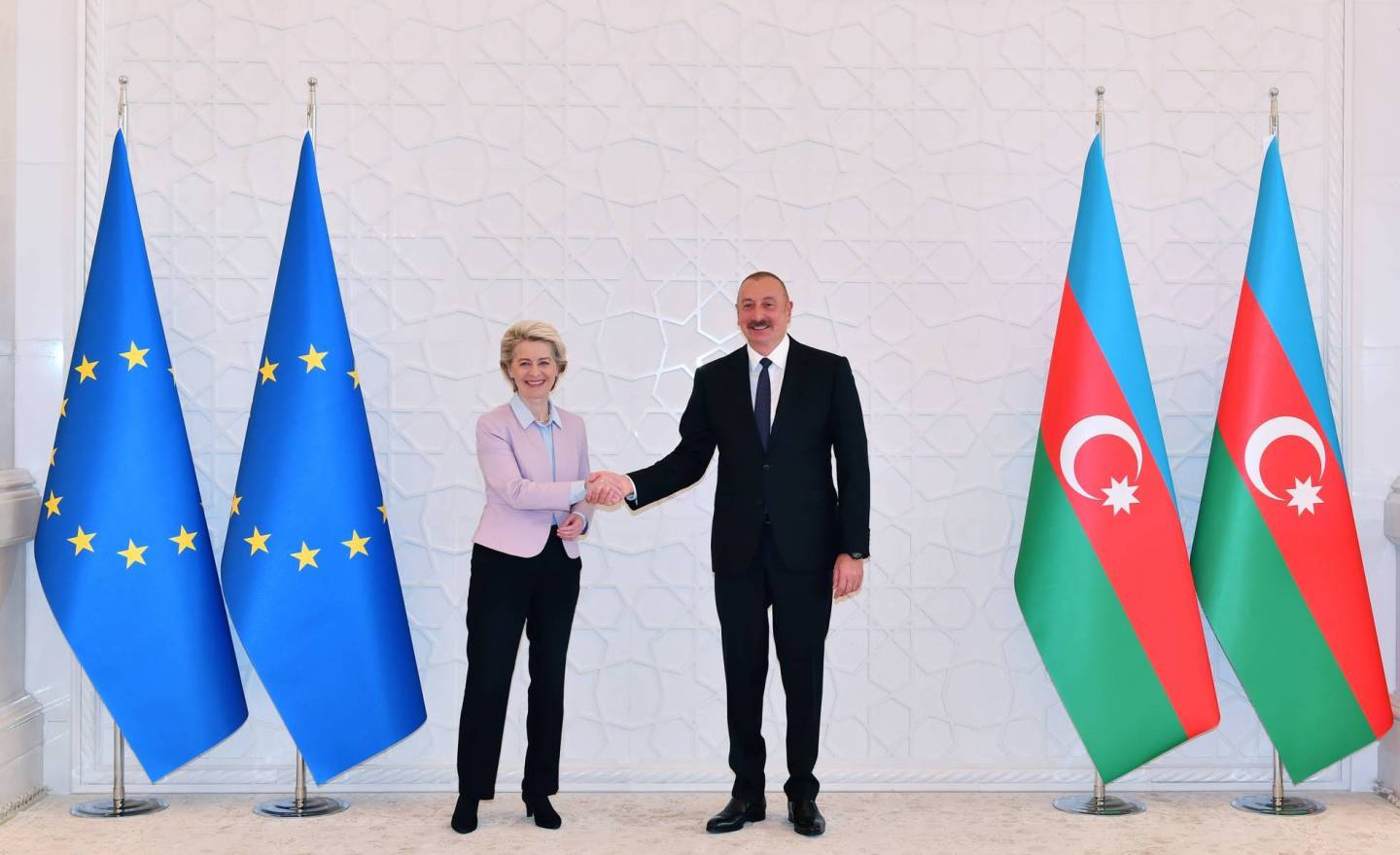 EU Chancellor Ursula von der Leyen and Azerbaijani President Ilham Aliyev shake hands onstage.