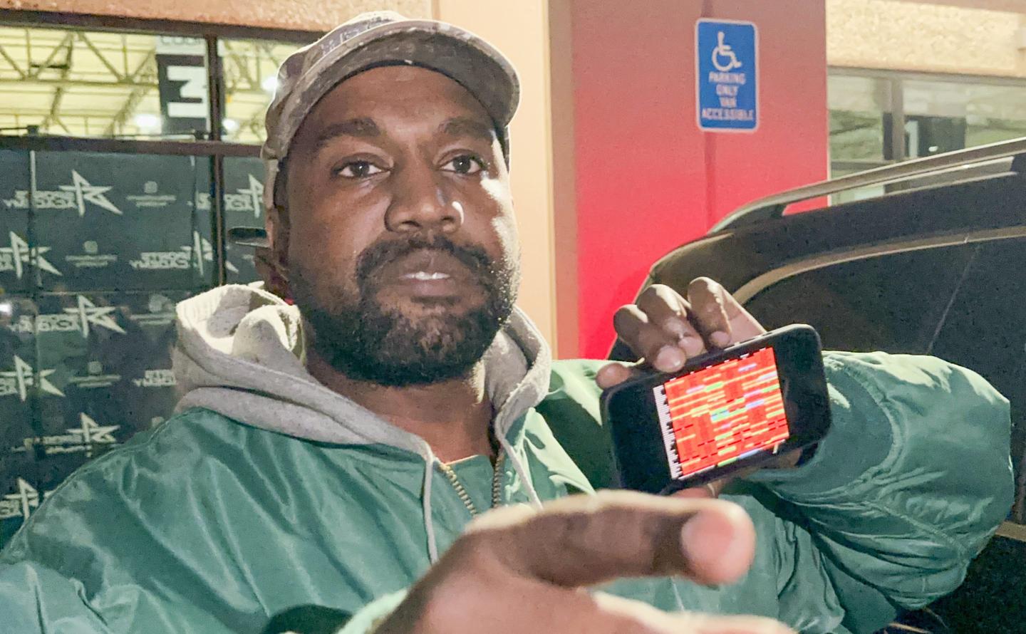 Kanye West showing his phone