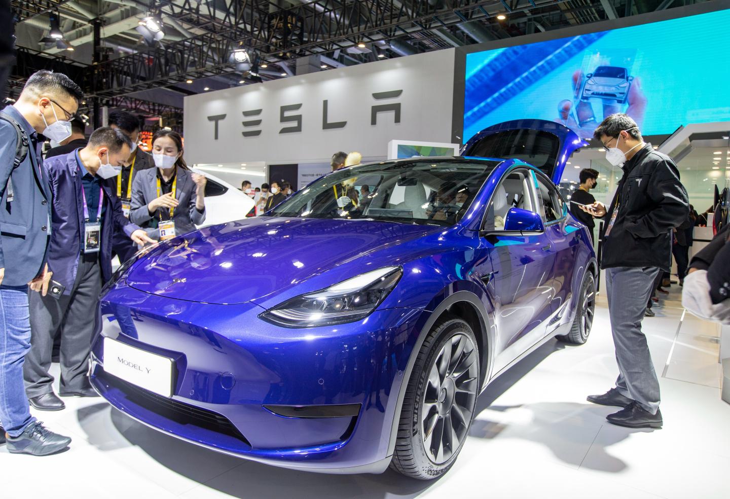 Visitors examine a Tesla model Y at the auto exhibition area of the 5th China International Import Expo in Shanghai, China, November 7, 2022. 
