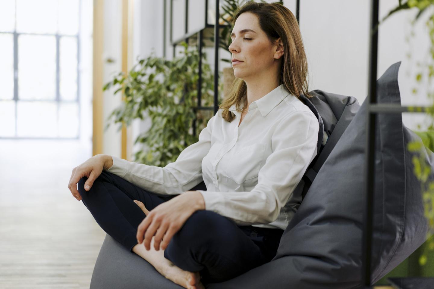woman meditating on couch