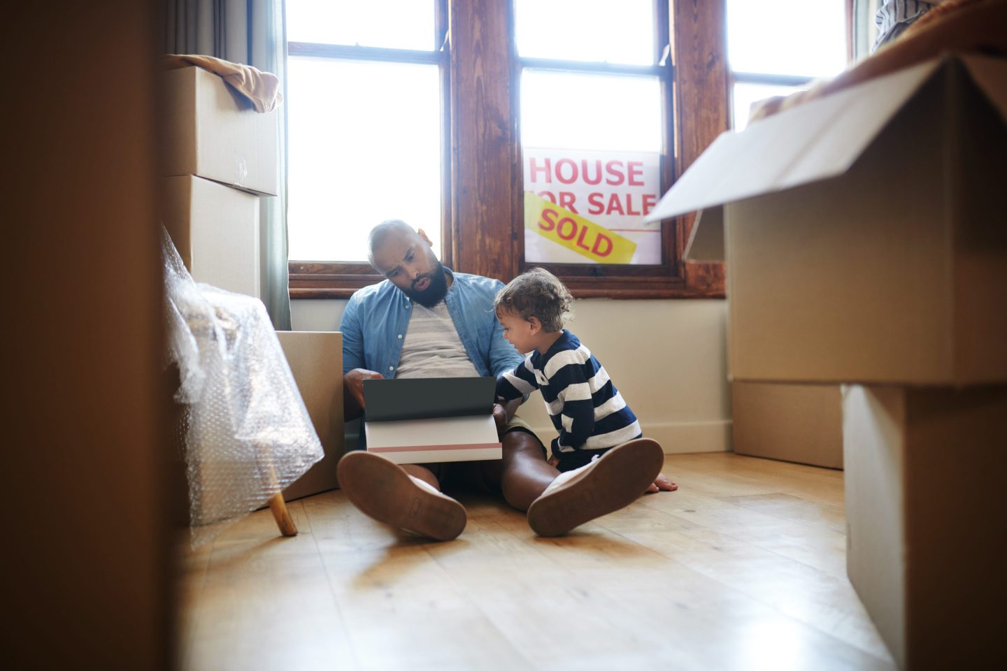 father and son in newly purchased home