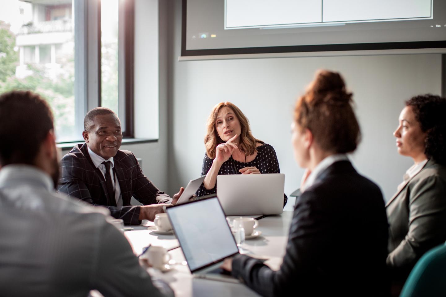 Close up of a group of business people having a meeting in a conference room.