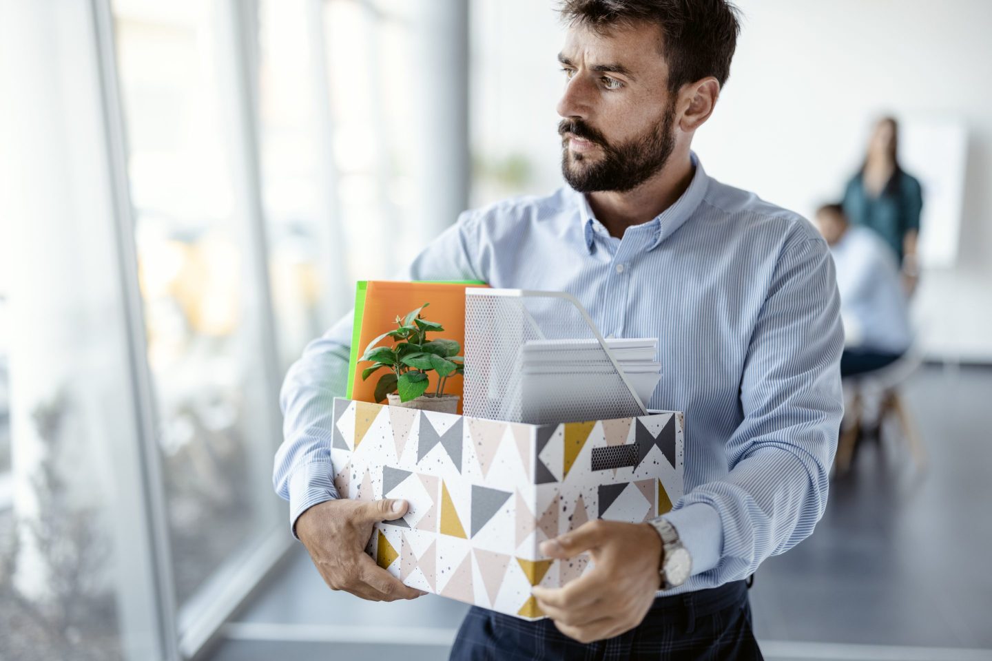 A employee with belongings in a box