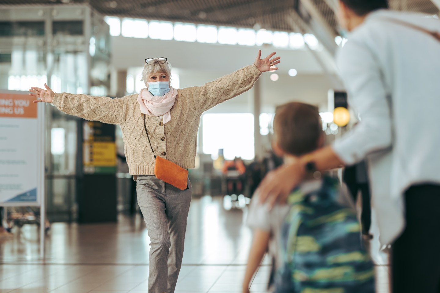 Grandmother welcoming her family at airport