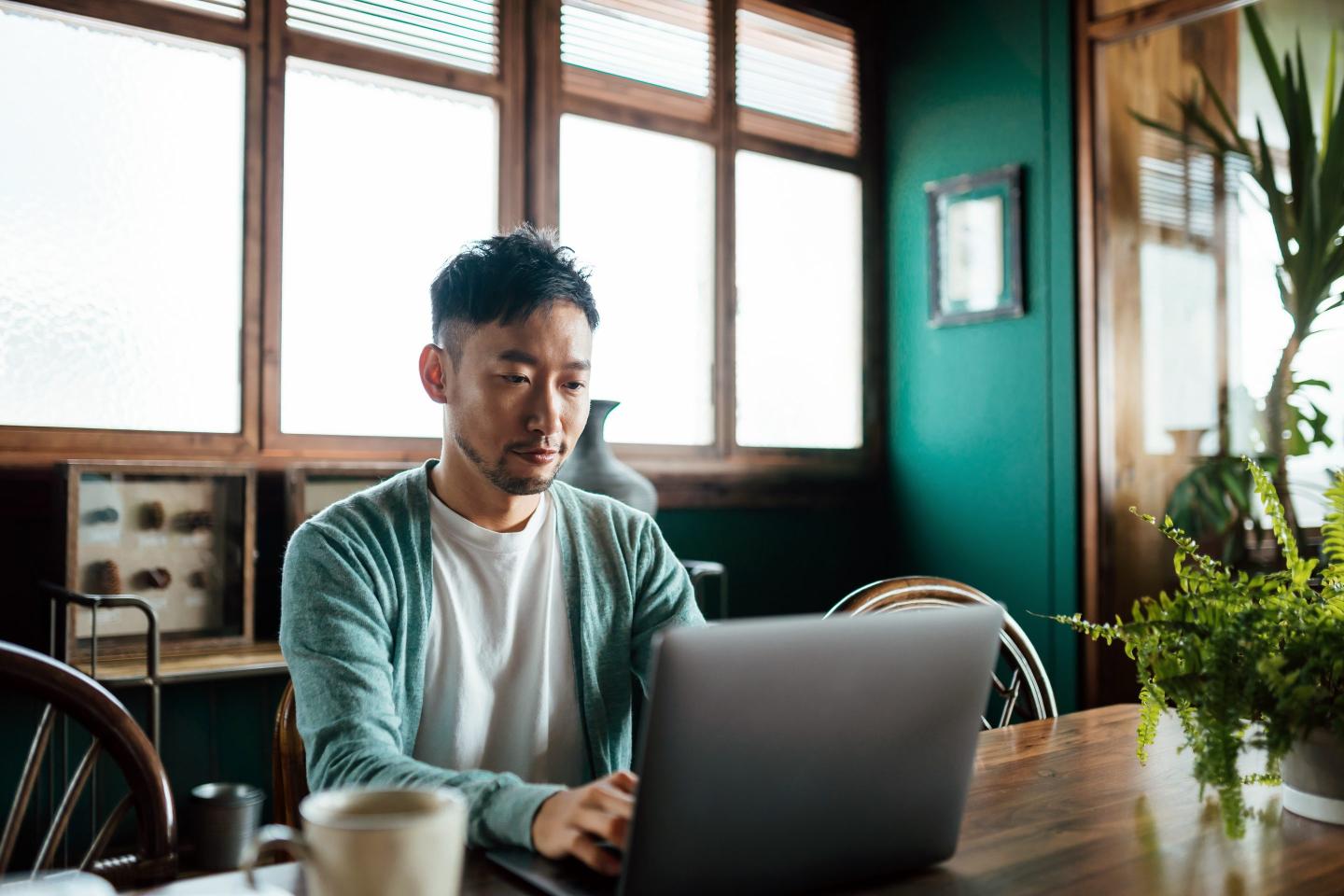 A young man working on a laptop