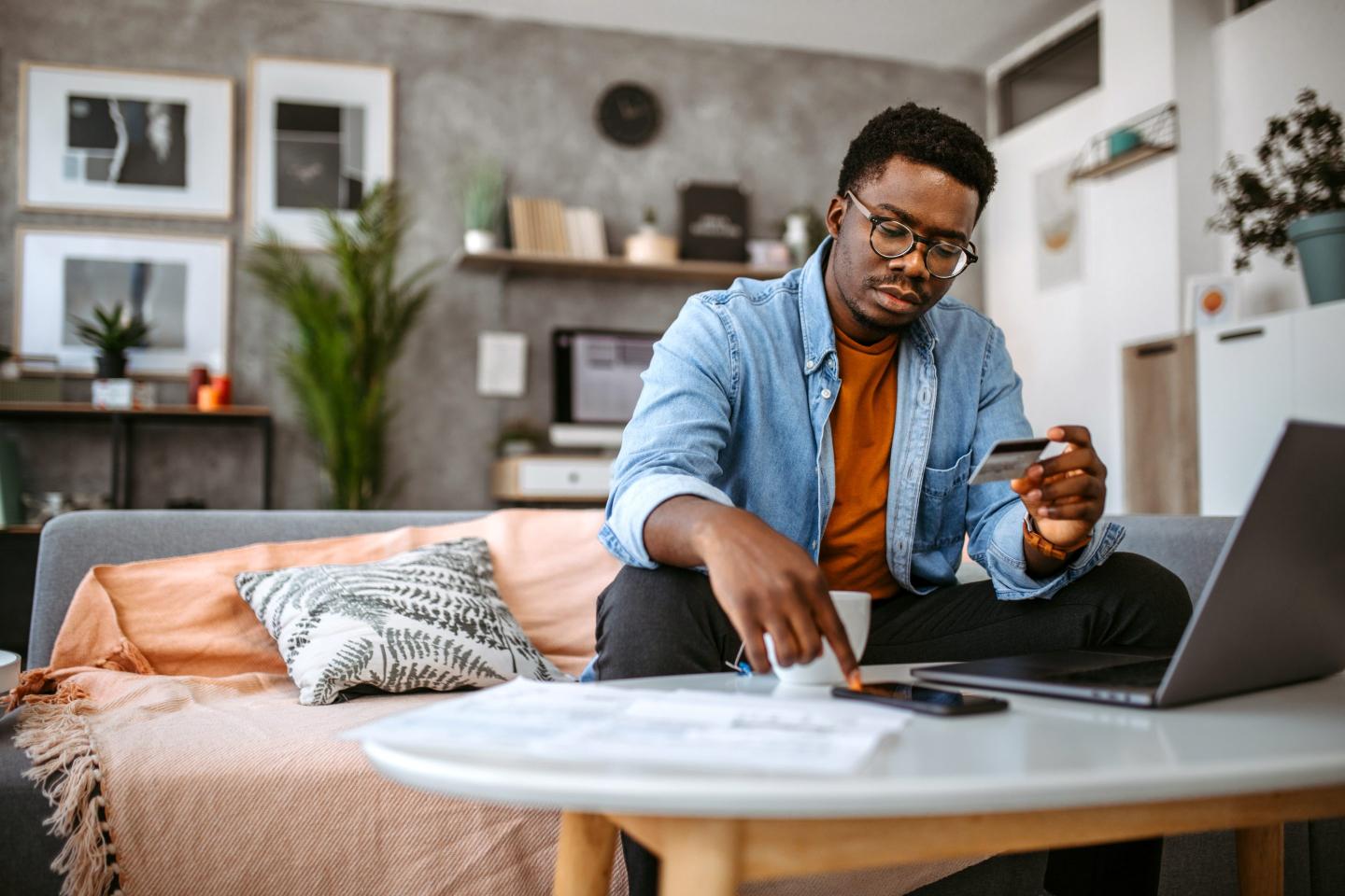 young Black man paying his bills