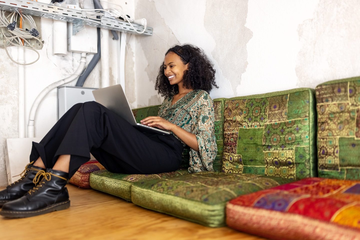 A woman on a laptop sitting on a couch