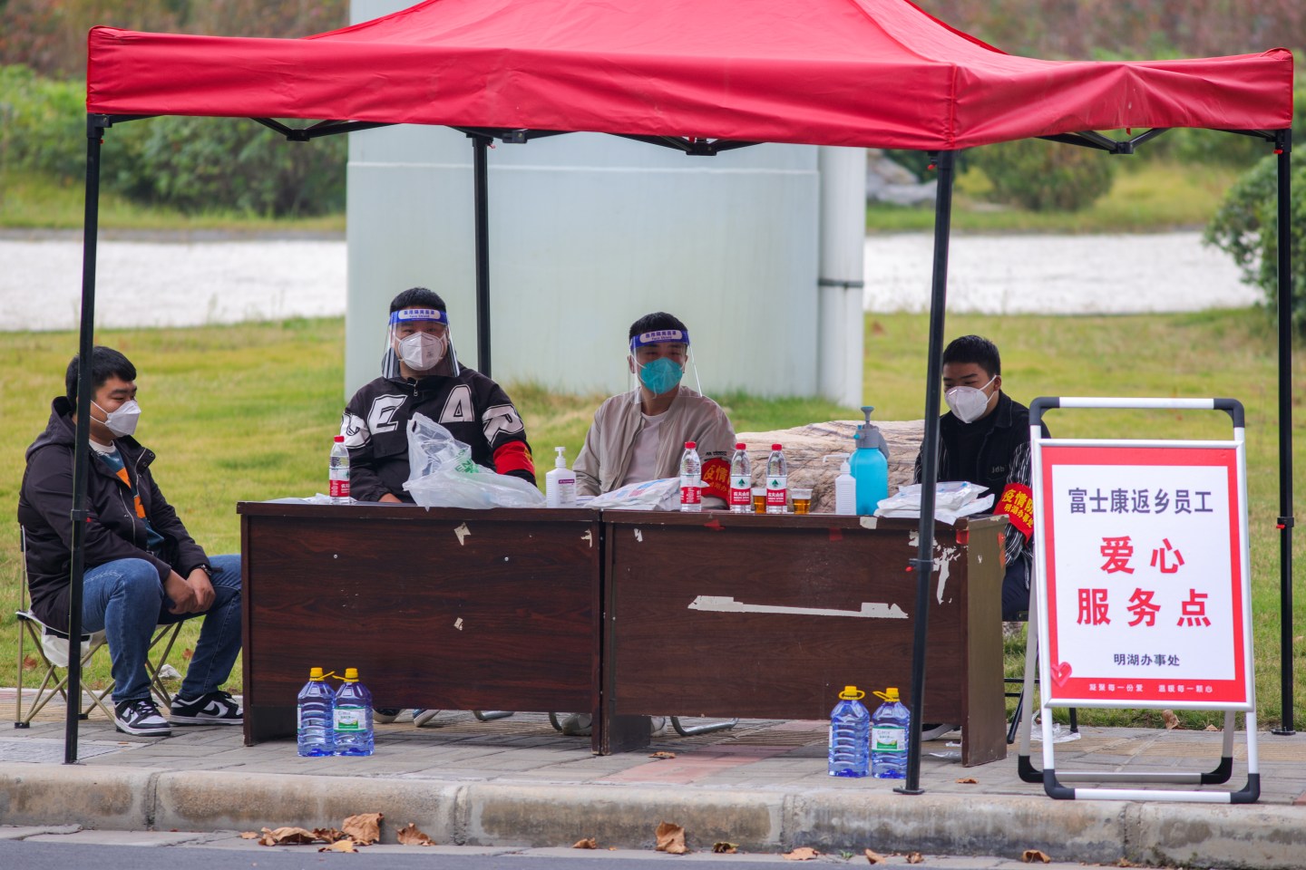 A service point for Foxconn employees before their departure on Oct. 30 in Zhengzhou, China. Shuttle buses have been arranged to facilitate the return trips of Foxconn factory workers to their hometowns due to COVID-19 infections.