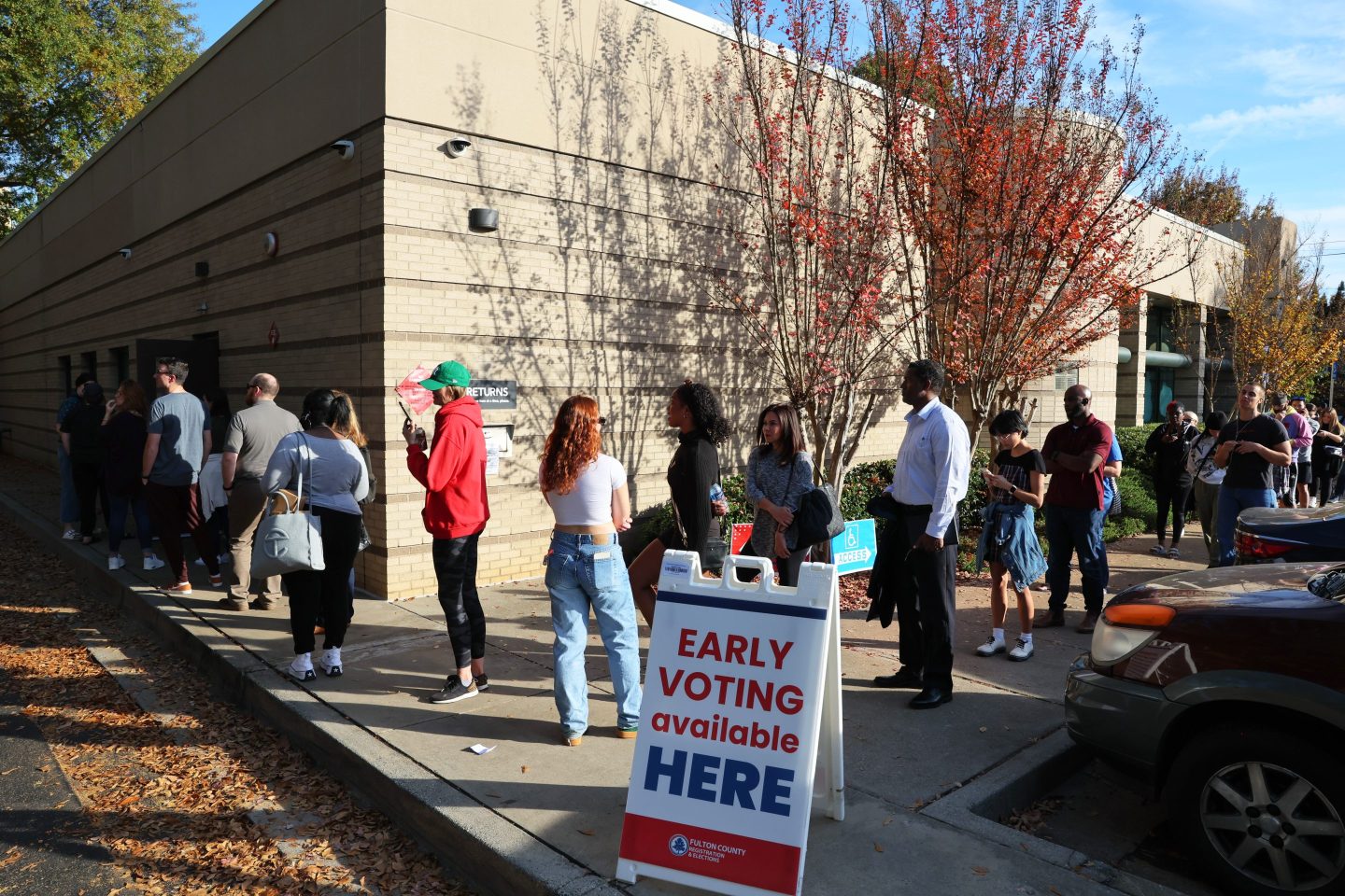 People wait in line for early voting for the midterm elections