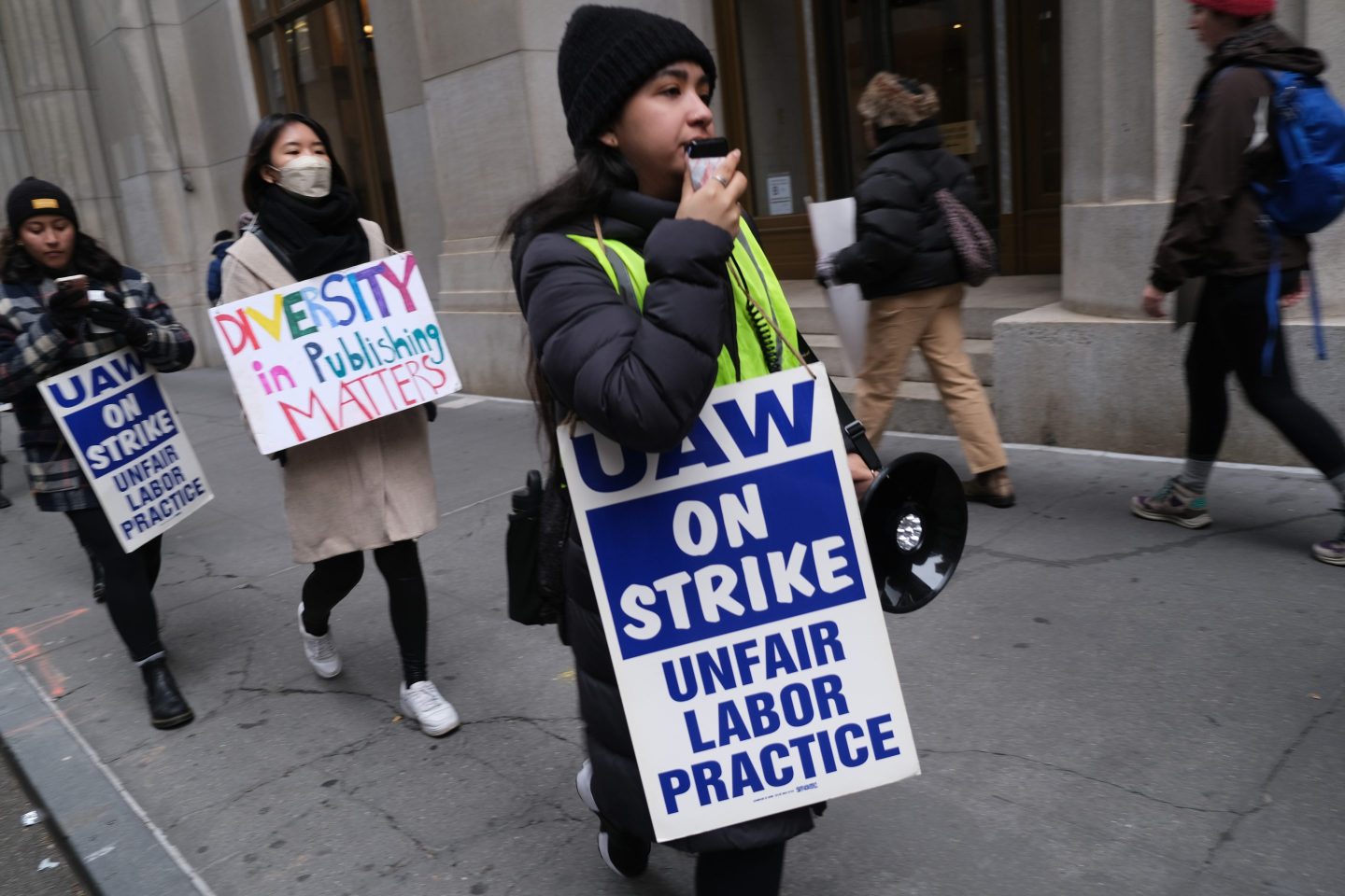 Employees of HarperCollins Publisher participate in a strike outside the company's offices in Manhattan