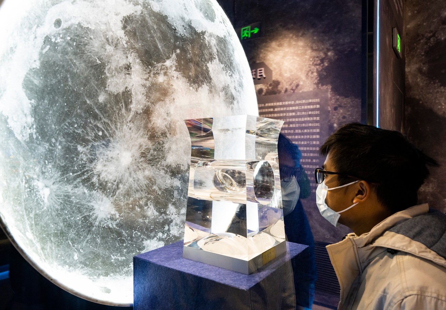 A visitor watches lunar soil sample at China Space Museum on Nov. 16, 2022 in Beijing. Founded in 1992 in Beijing, the China Space Museum reopened on November 16 after an upgrade.