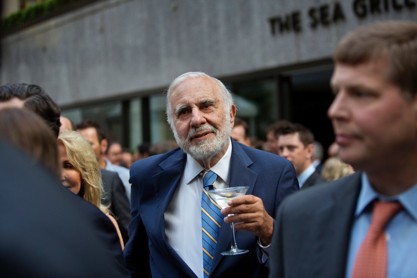 Billionaire activist investor Carl Icahn holds a martini glass while attending the Leveraged Finance Fights Melanoma charity event in New York, on May 19, 2015.