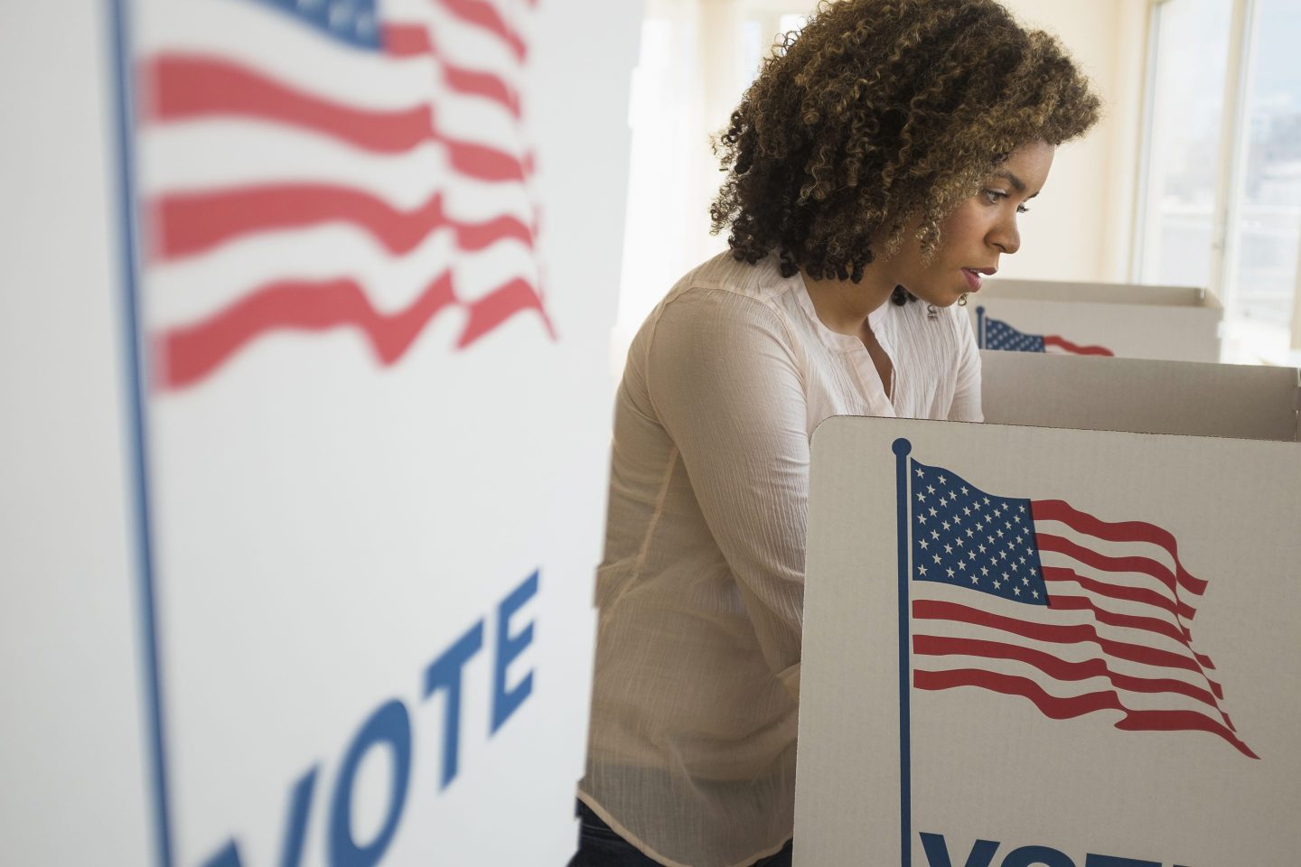 A woman is pictured casting her ballot.