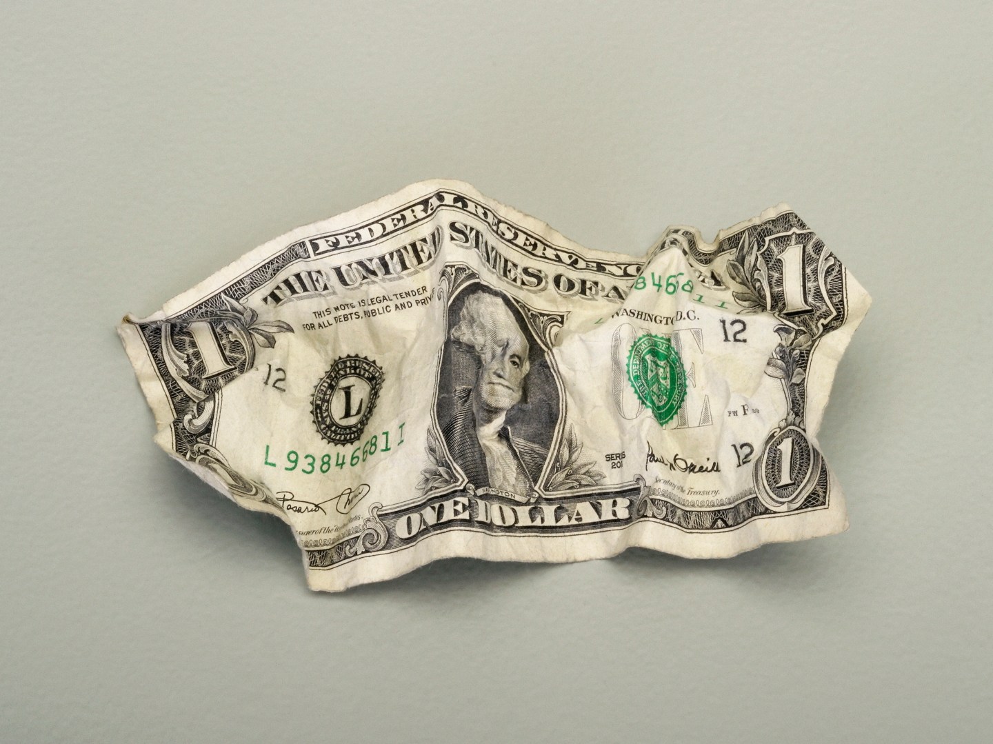 A crumpled one dollar bill.