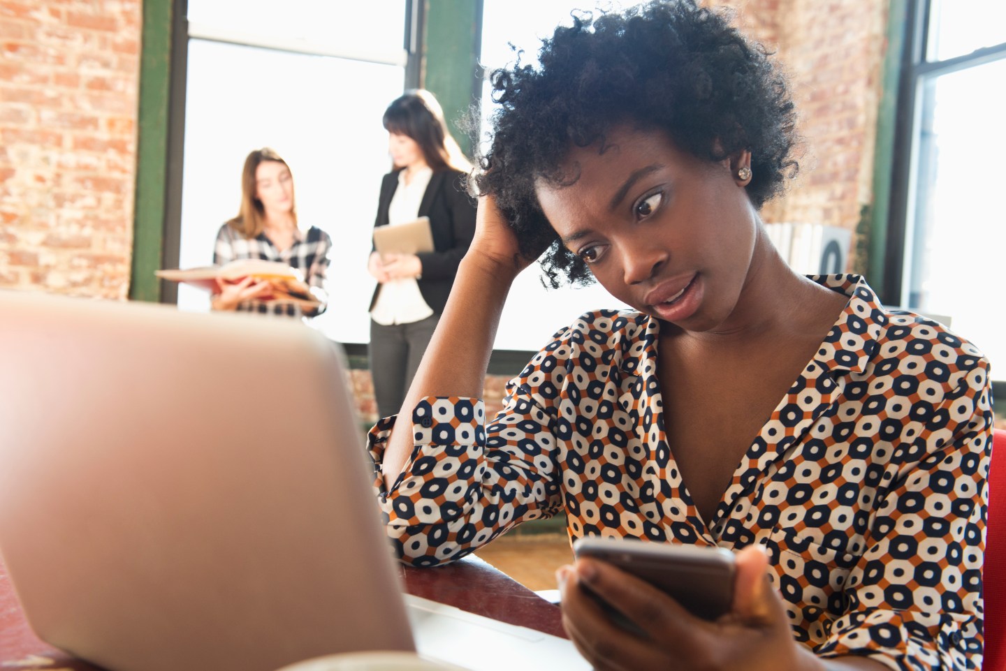 Confused woman looking at laptop
