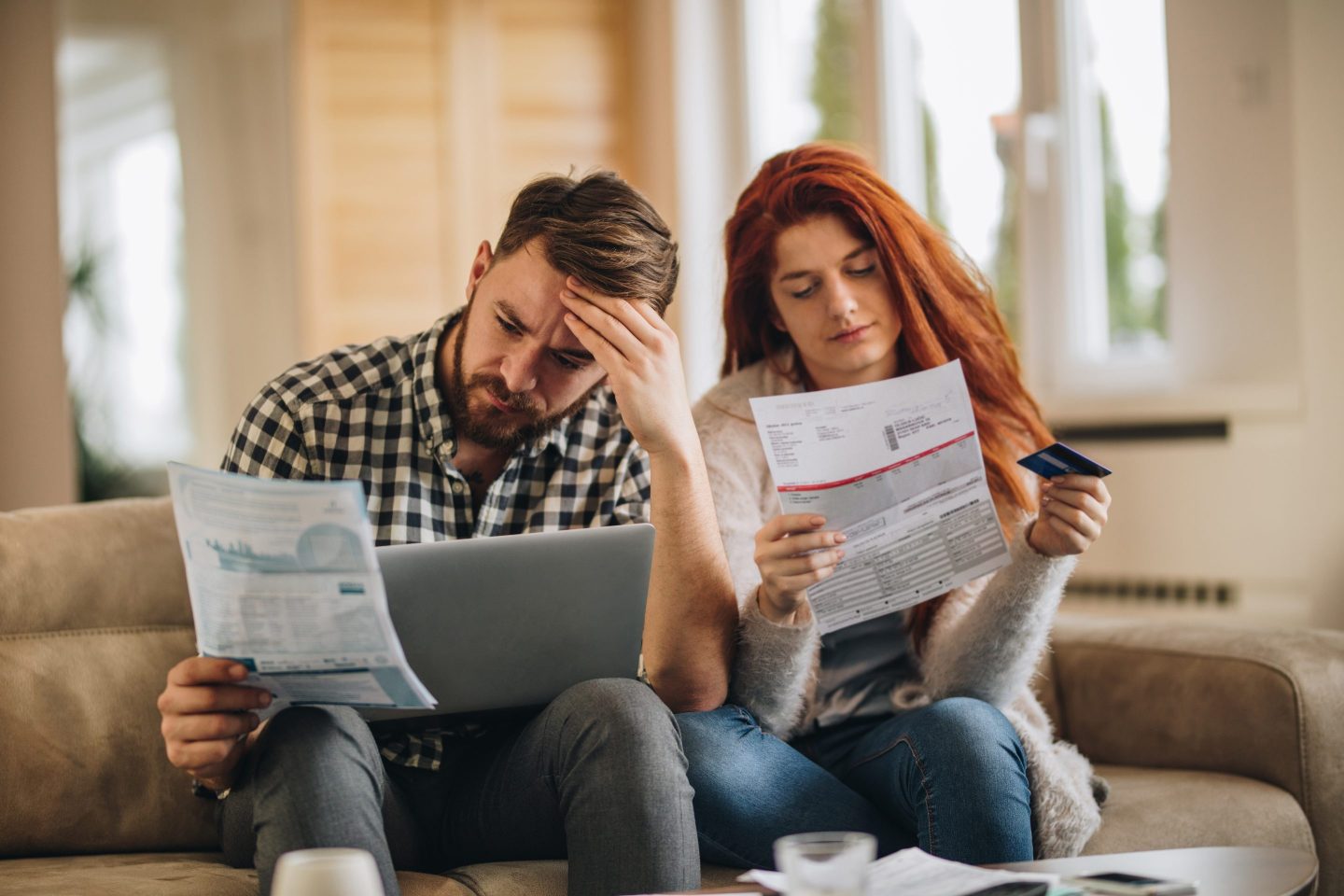 Worried couple feeling frustrated while have to pay their bills