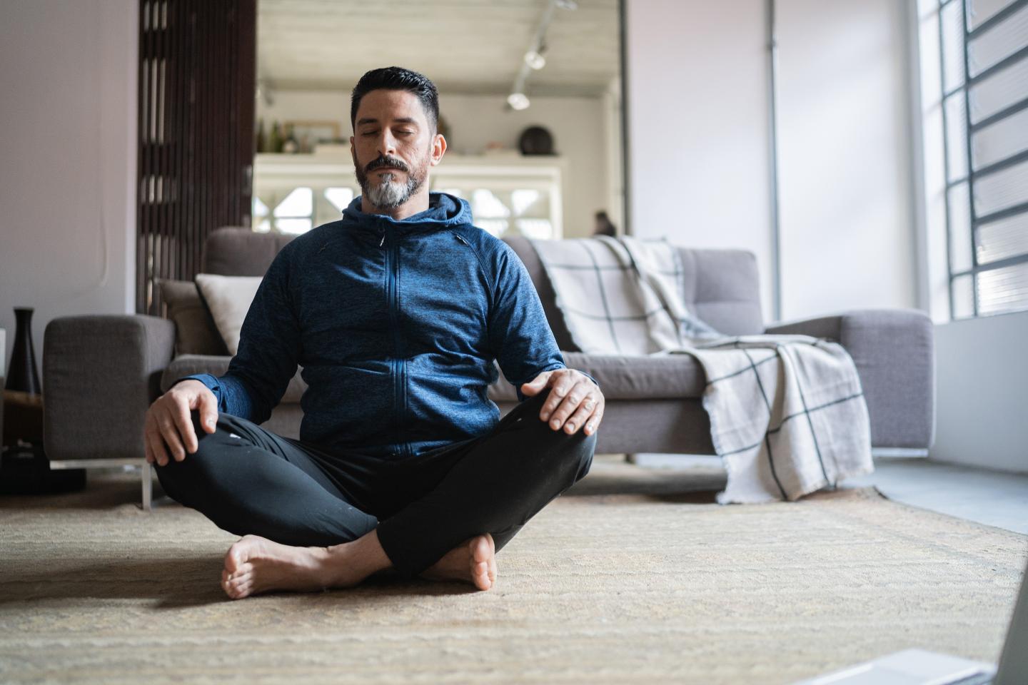 Man meditating at home.