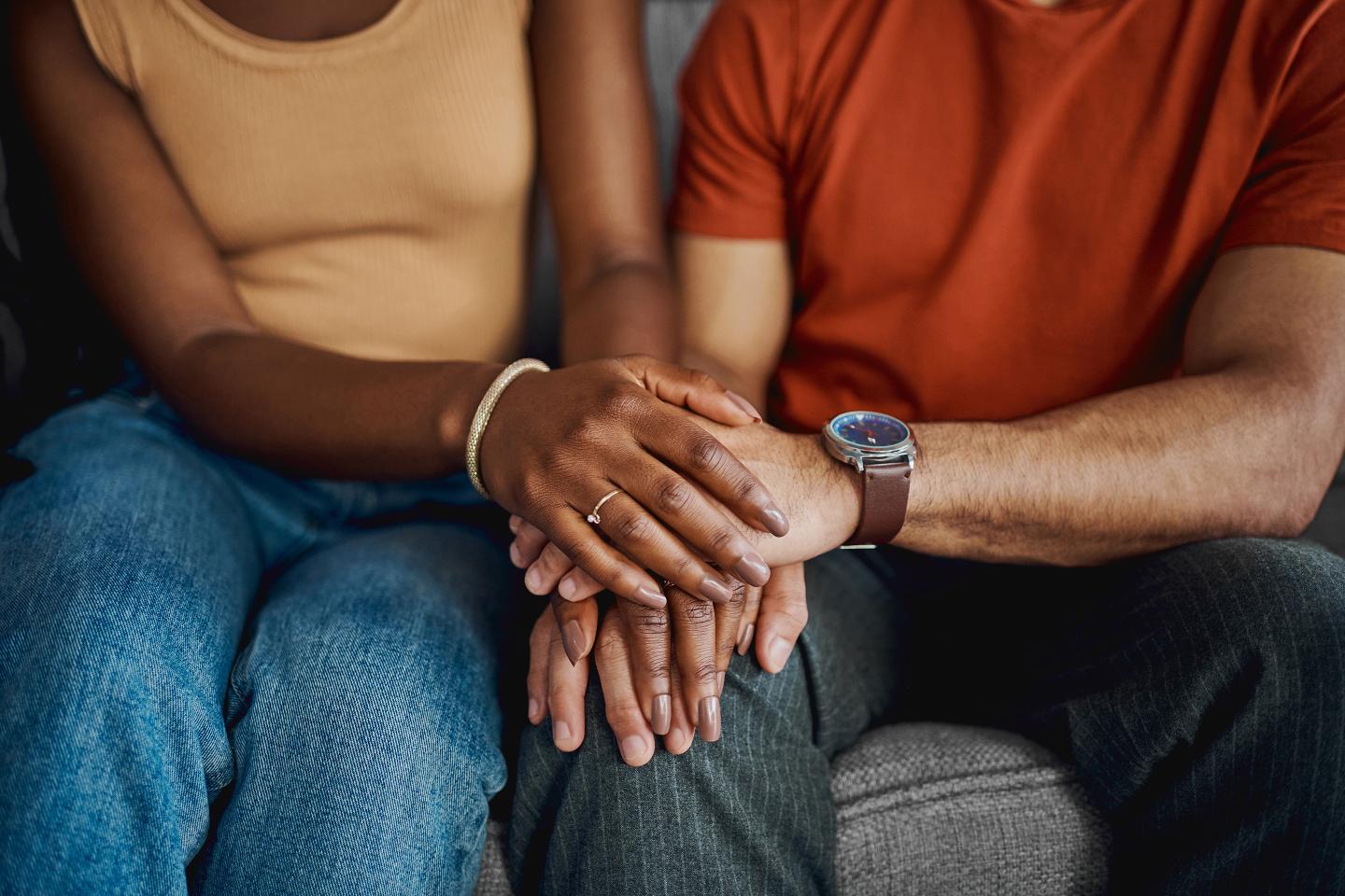Couple holding hands.