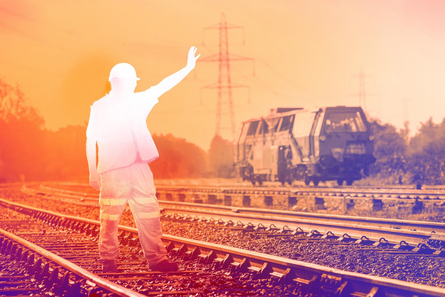 Photo illustration of rail worker fading away on a train track