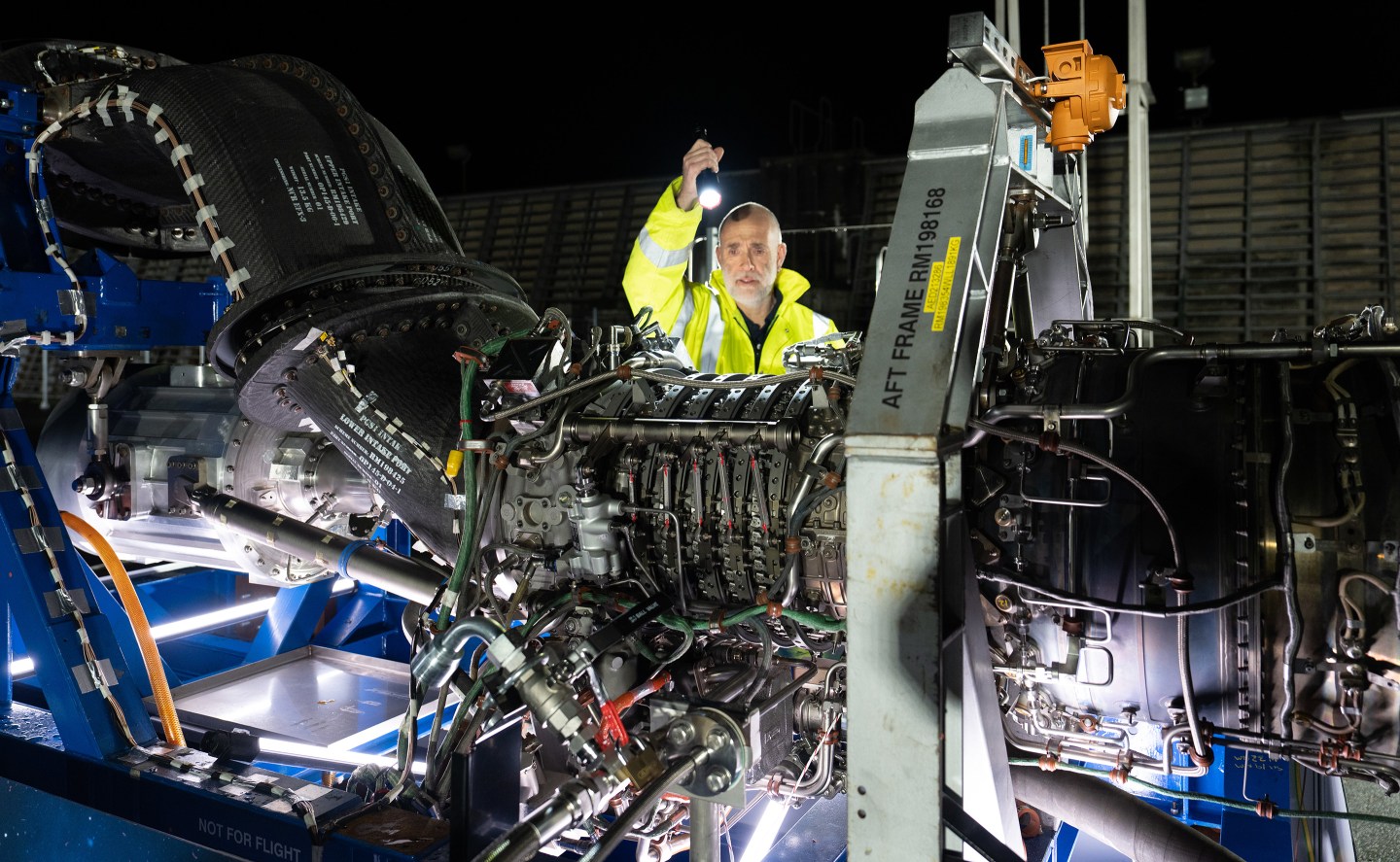 A Rolls-Royce engineer working with an engine