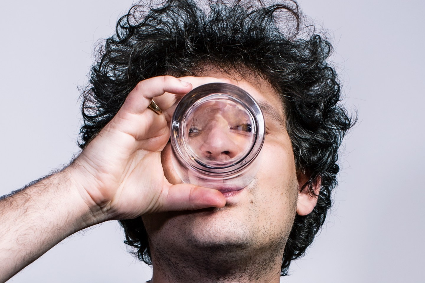 Portrait of Sam Bankman-Fried drinking water from a glass