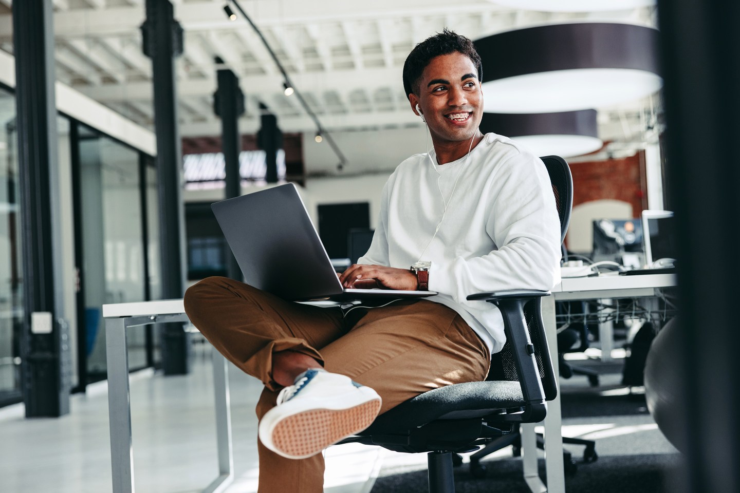 Cheerful software developer smiling in an office.