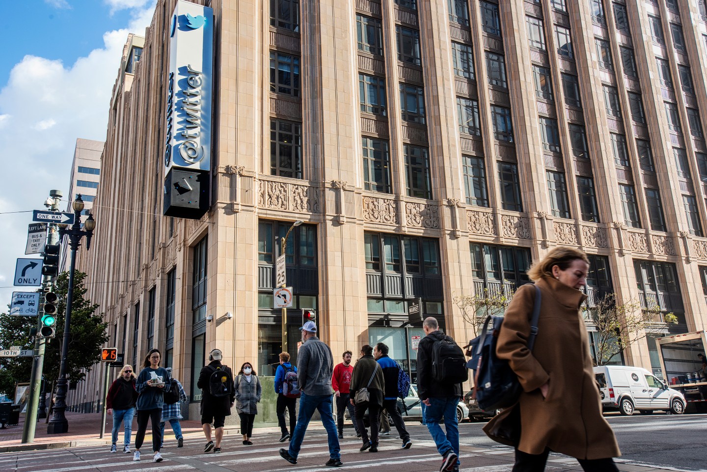 Picture of Twitter building with people walking by