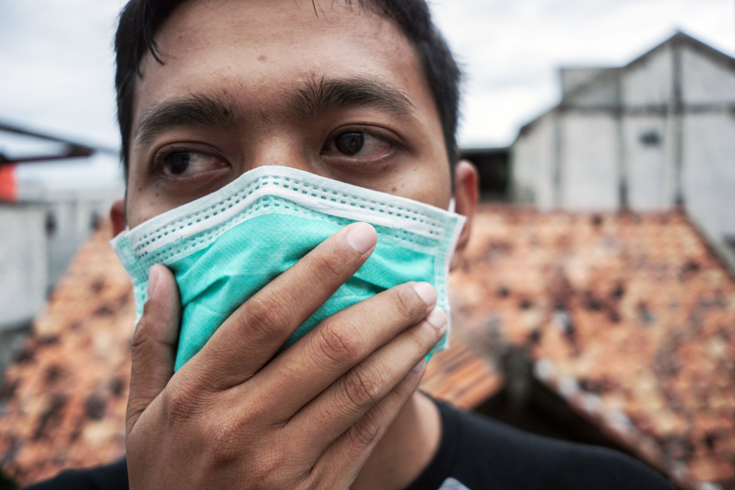 Young asian man wearing a surgical mask