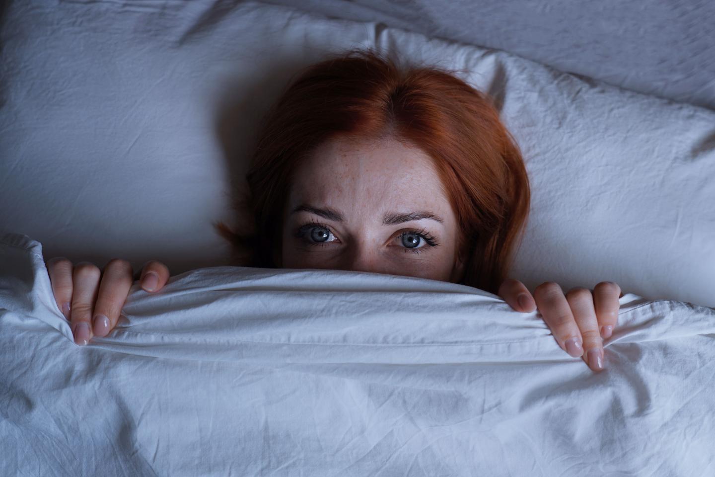 Sleepless woman lying in bed