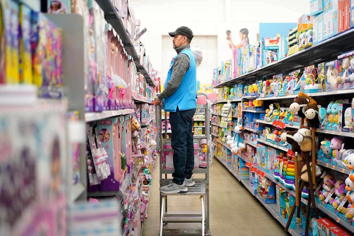 An employee stocks shelves at a Walmart