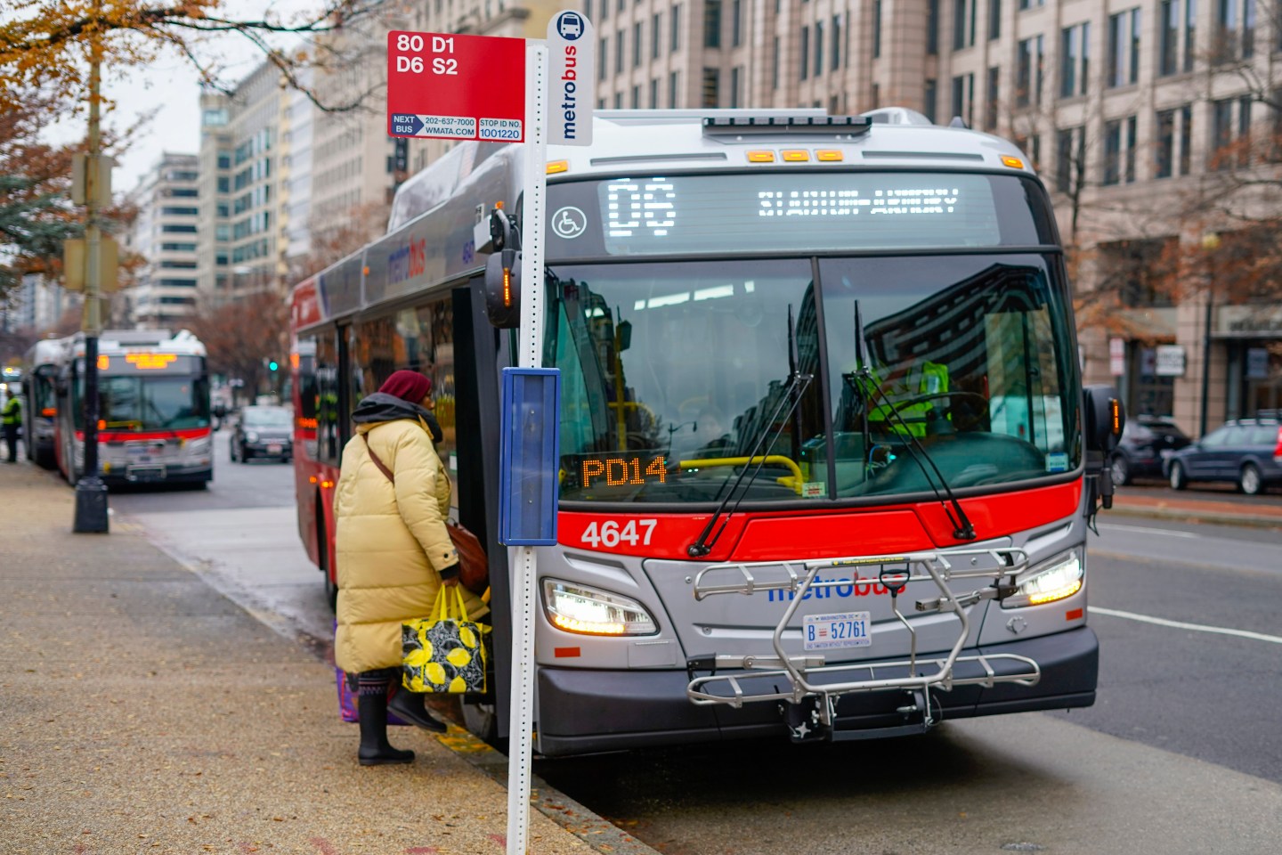 A passenger boards a Metrobus in downtown Washington on Dec. 7, 2022. The Washington D.C. government voted to waive fares for Metrobus rides within city limits starting July, 1, 2023, becoming the nation's most populous city to offer free public transit. 