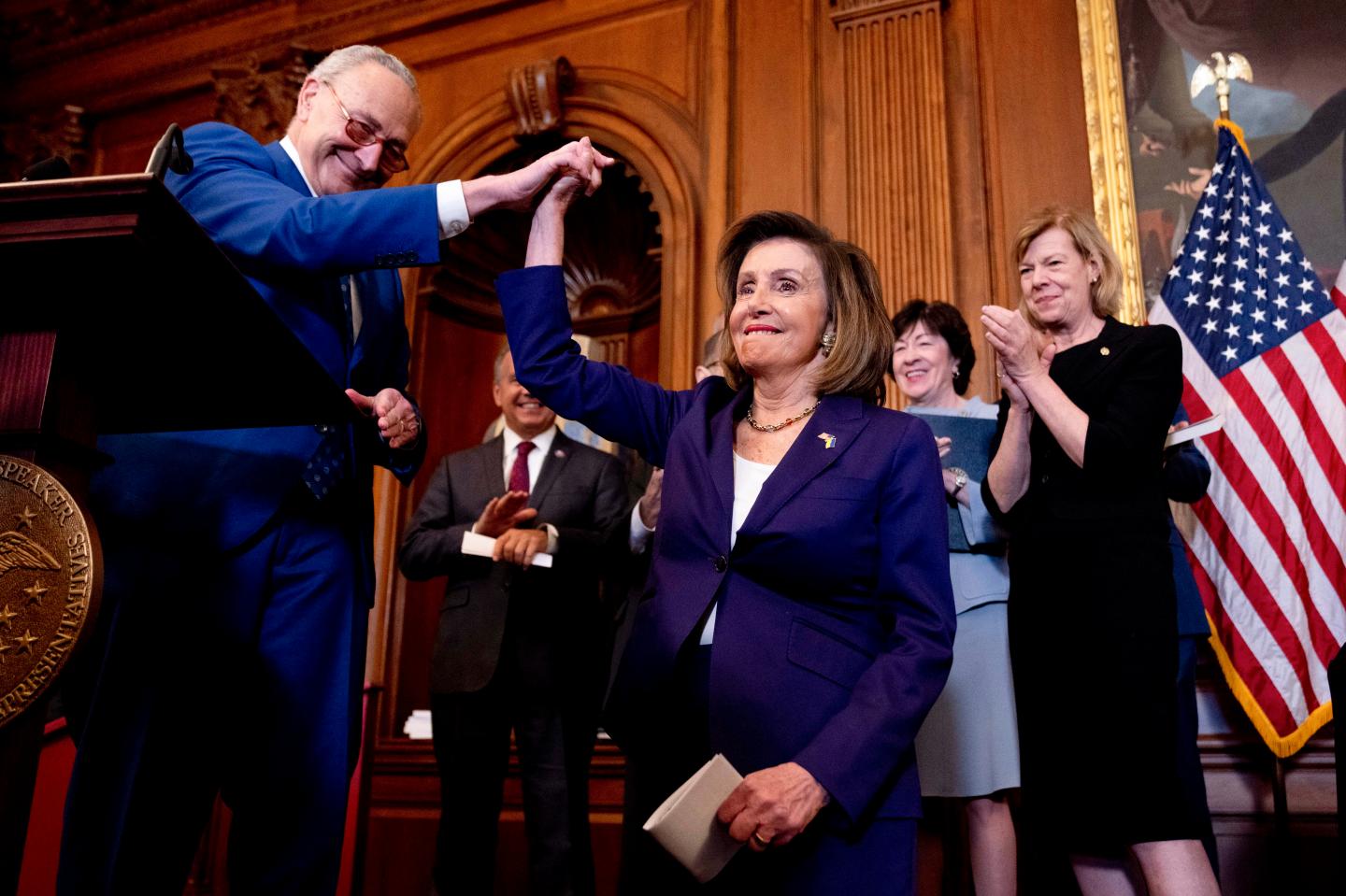 Nancy Pelosi celebrates with Chuck Schumer