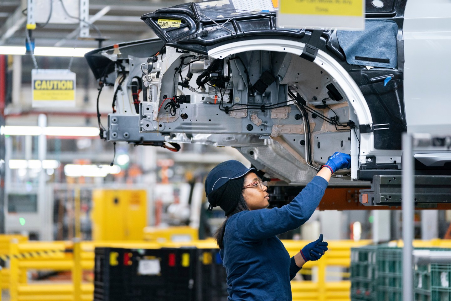 A BMW factory worker inspects equipment