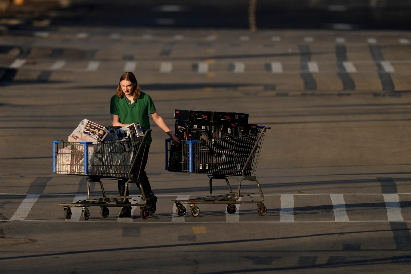 A shopper leaves a Walmart after attending a Black Friday sale on Nov. 25, 2022, in Shawnee, Kan. The Fed is expected to signal that it plans more hikes next year than it had previously forecast to try to conquer the worst inflation bout in four decades.