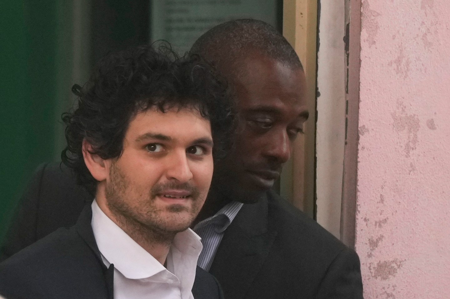 FTX founder Sam Bankman-Fried, is escorted from the Magistrate Court in Nassau, Bahamas, Dec. 21, 2022, after agreeing to be extradited to the U.S.