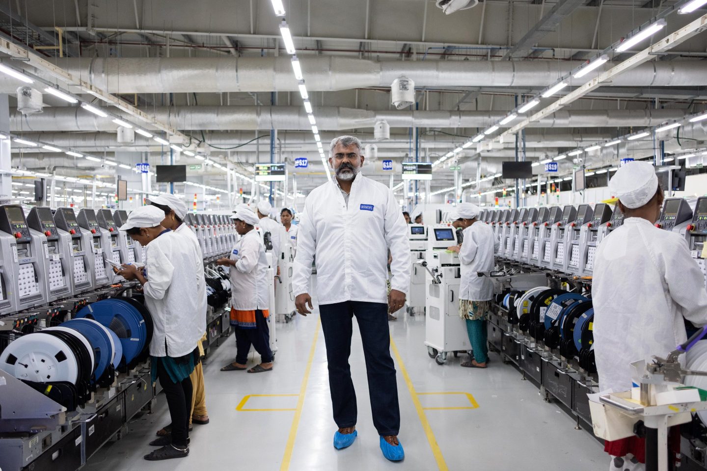 A manager stands in a Foxconn plant in India in 2019