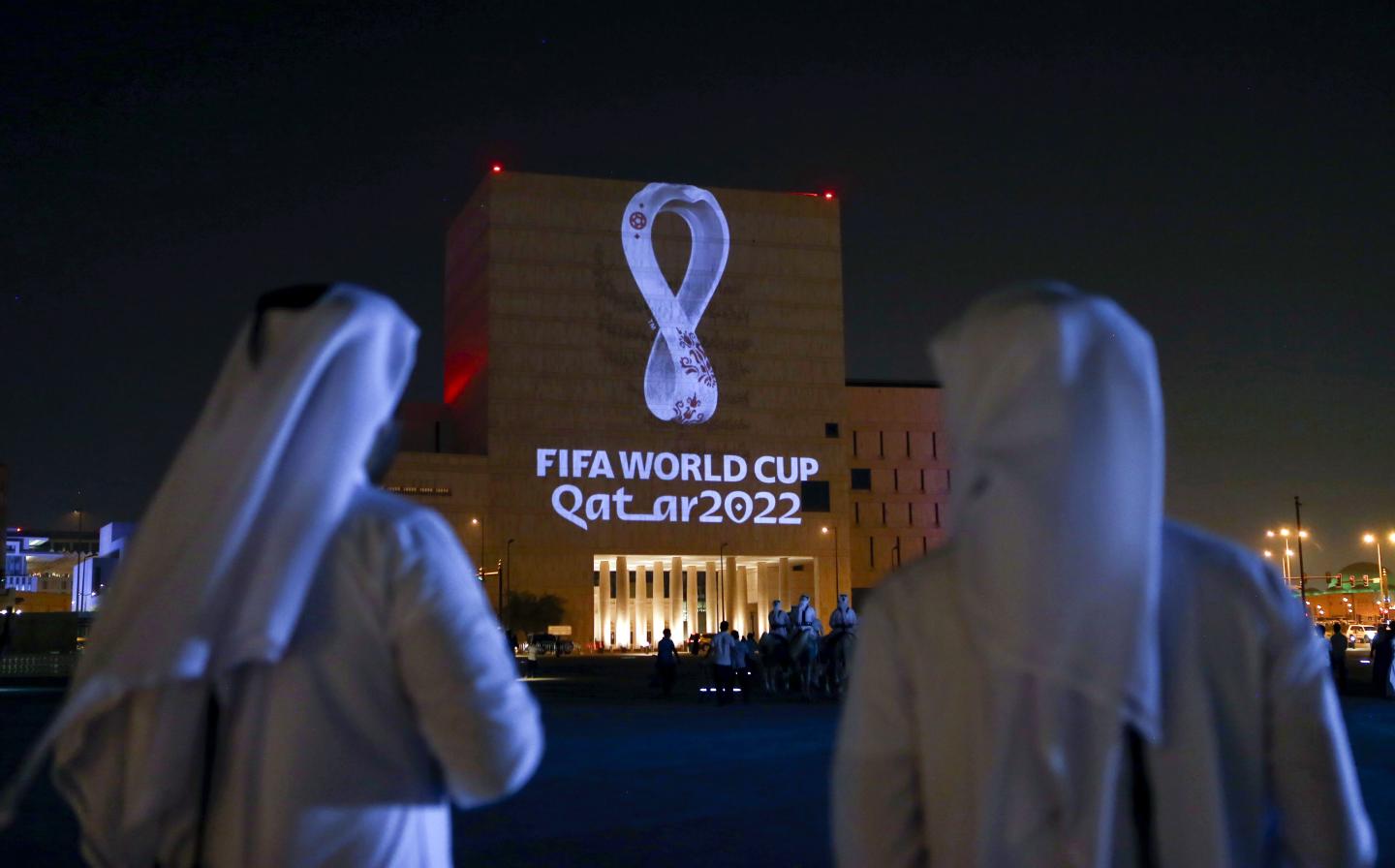 Qataris gather at the capital Doha's traditional Souq Waqif market as the official logo of the FIFA World Cup Qatar 2022 is projected on the front of a building on September 3, 2019.