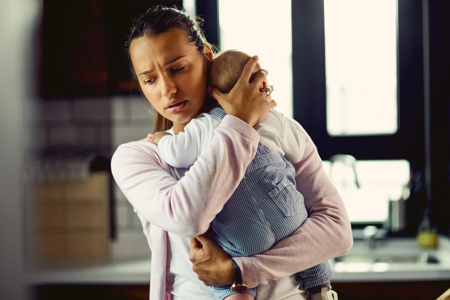 A mother holding her baby.