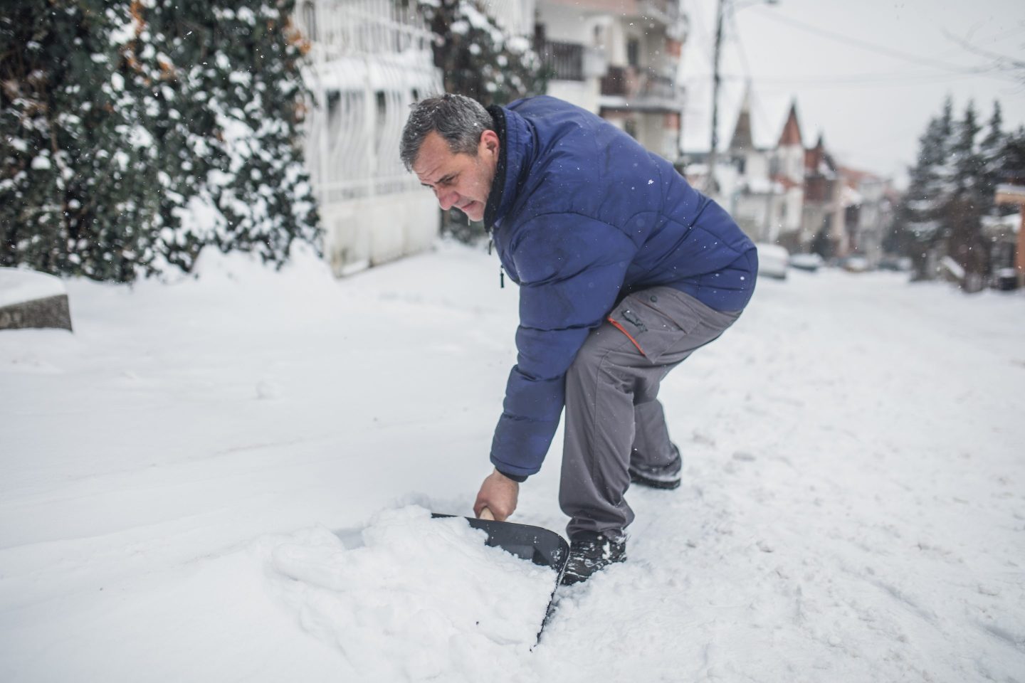 A senior man is ready to clear the snow