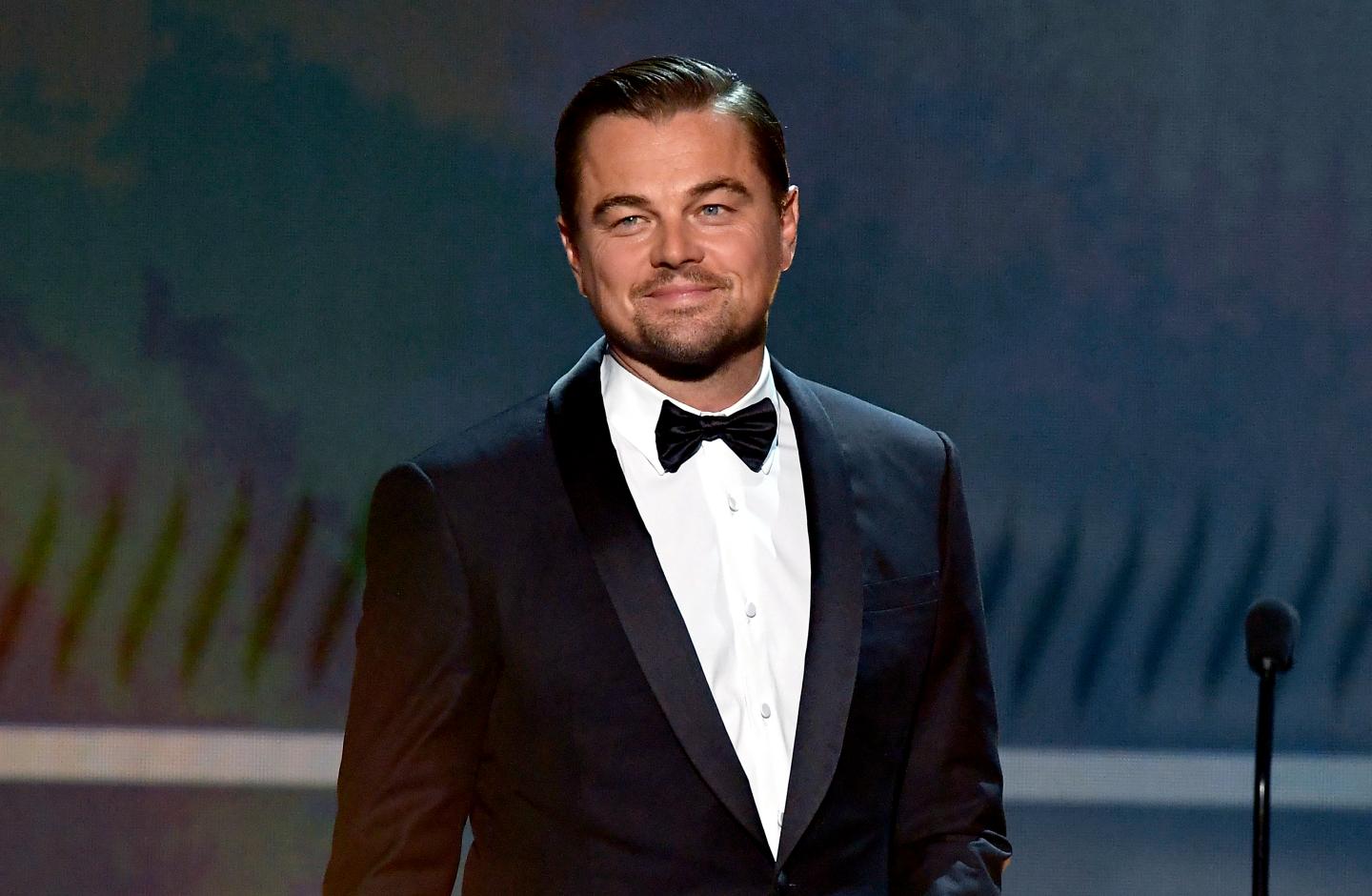 Leonardo DiCaprio, wearing black tie, speaks onstage during the 26th Annual Screen Actors Guild Awards in 2020.