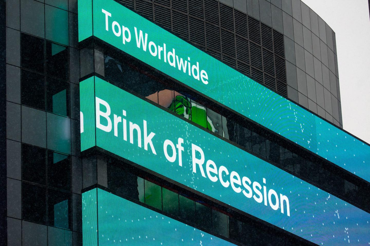 A news ticker displays economic news in front of Morgan Stanley in the Times Square area of Manhattan