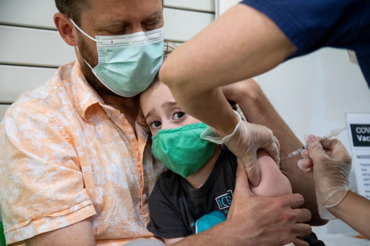 A young child receives a COVID vaccination in Brooklyn
