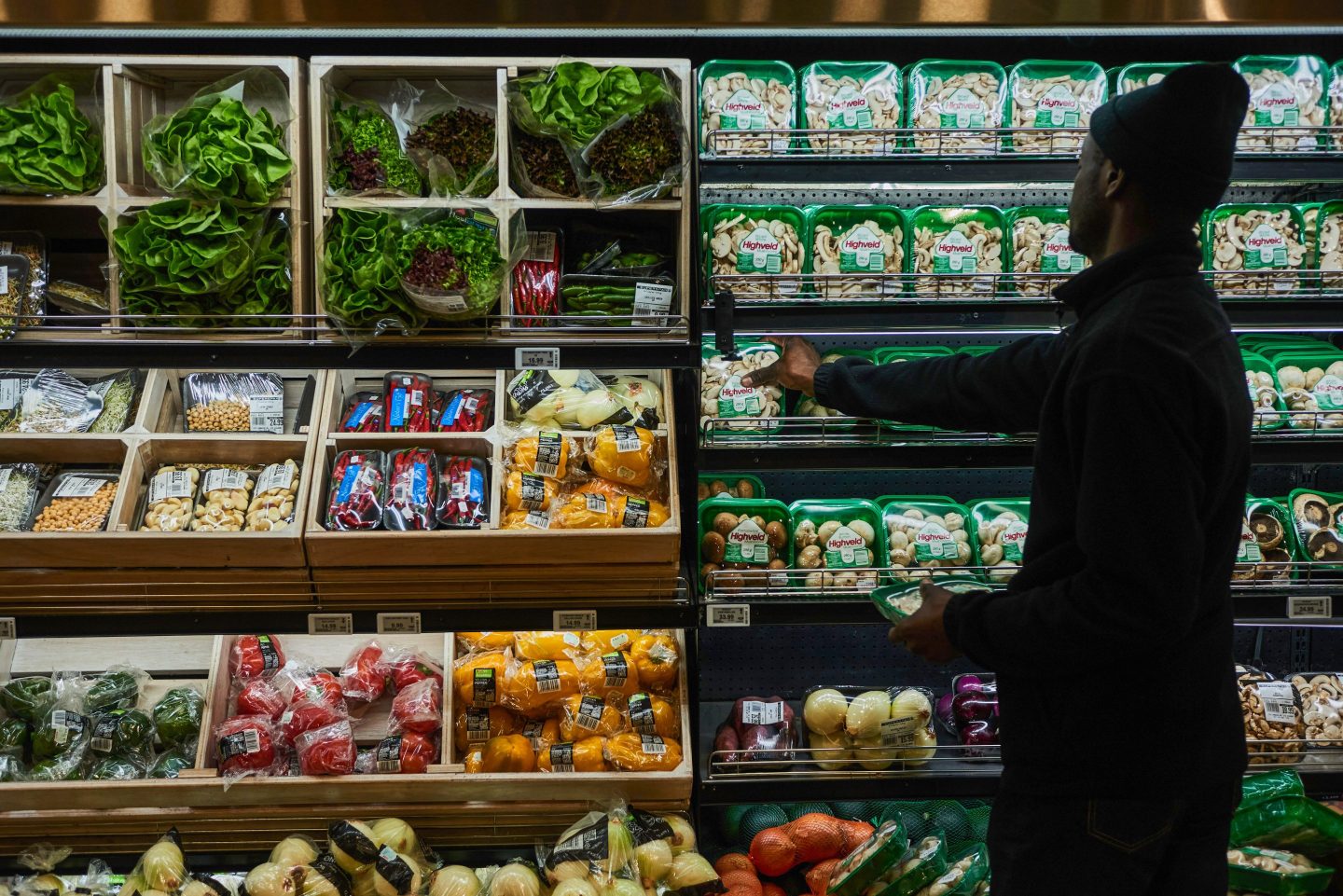 A customer picks packets of mushrooms from the fresh produce aisle inside a Spar Group Ltd. supermarket