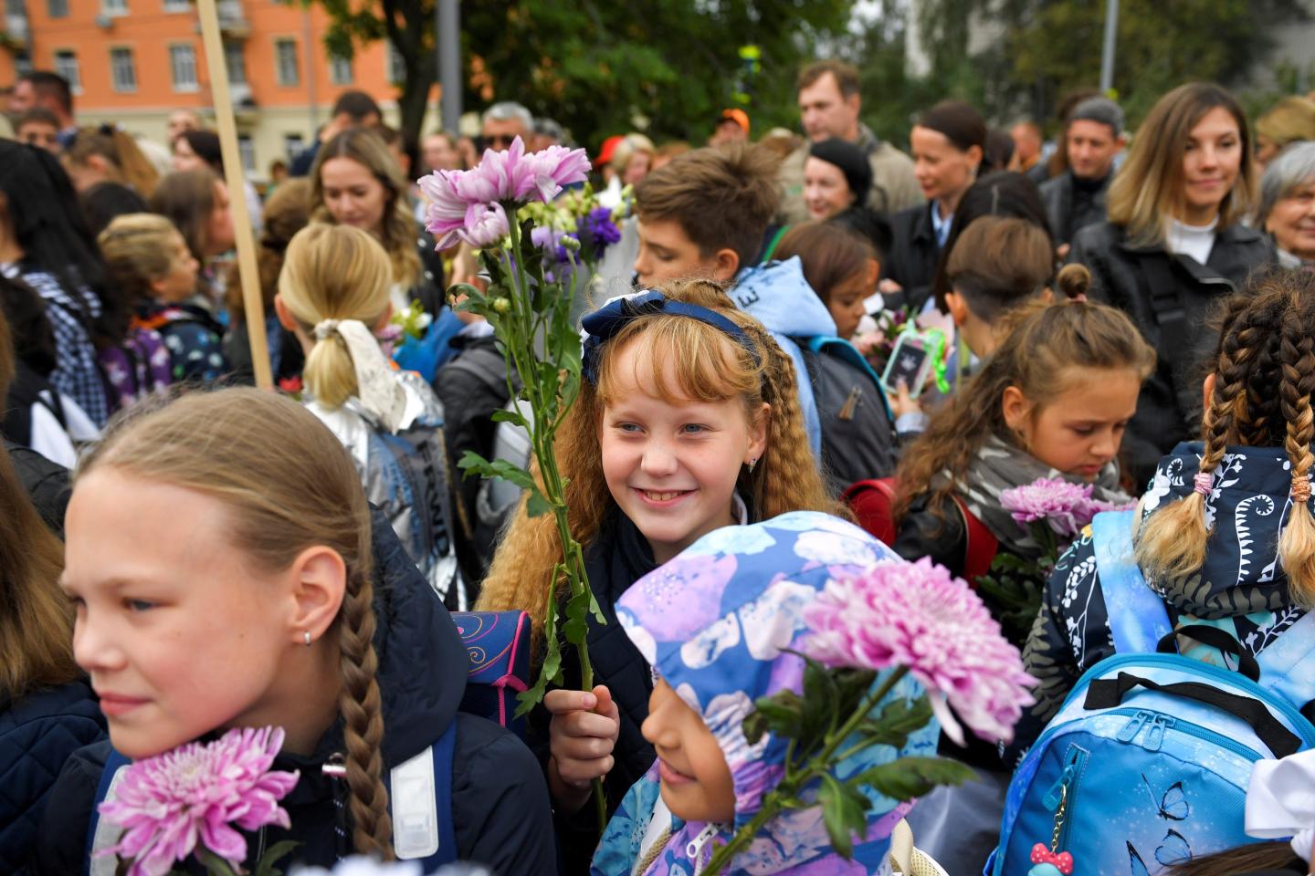 Russian schoolchildren hold bouquets of flowers while partaking in a. school ceremony on September 1, 2022, in Moscow, Russia.