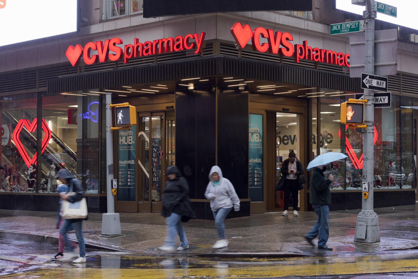 A CVS store with pedestrians walking by