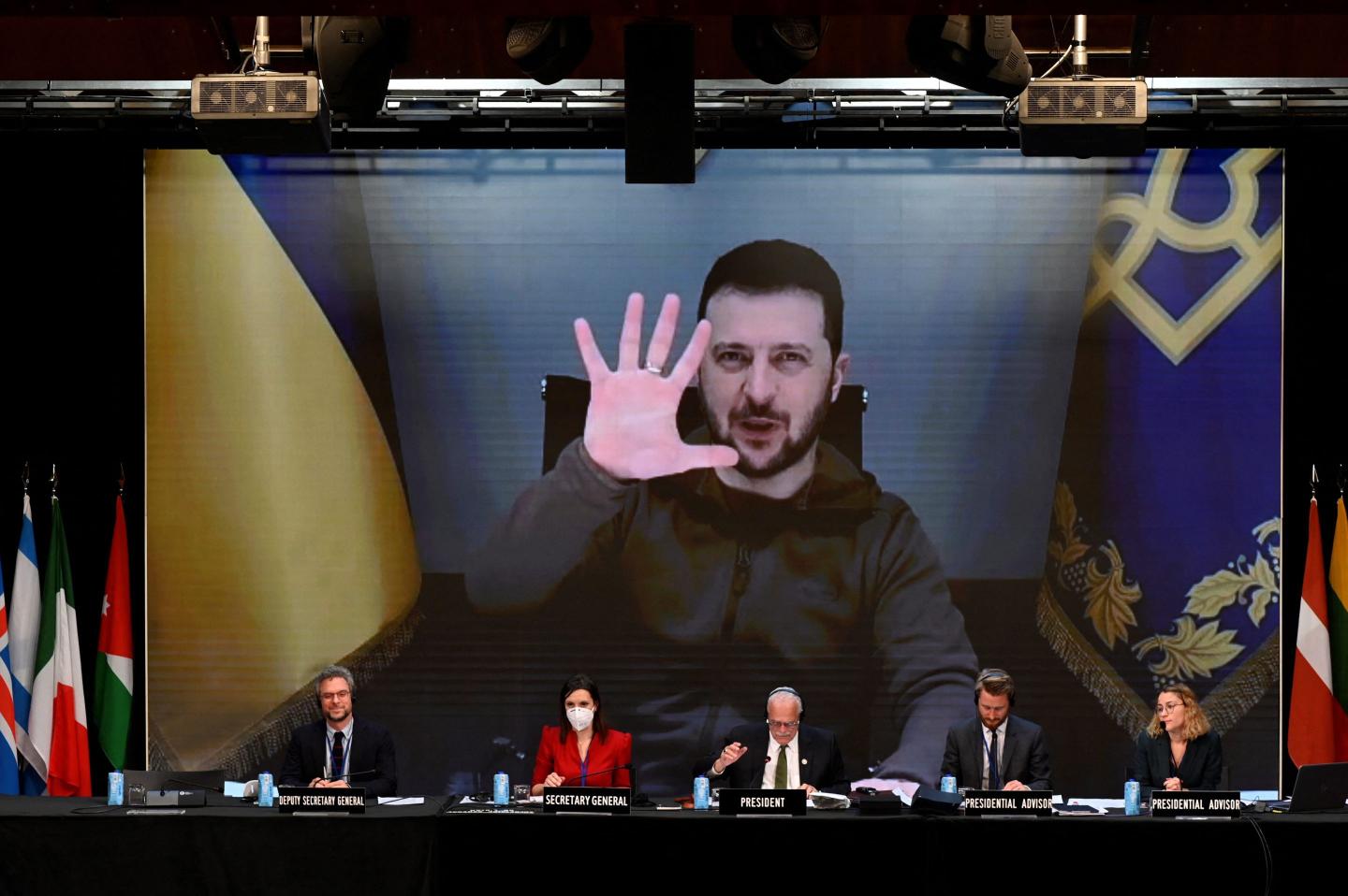 Ukrainian President Volodymyr Zelensky is seen on a giant screen