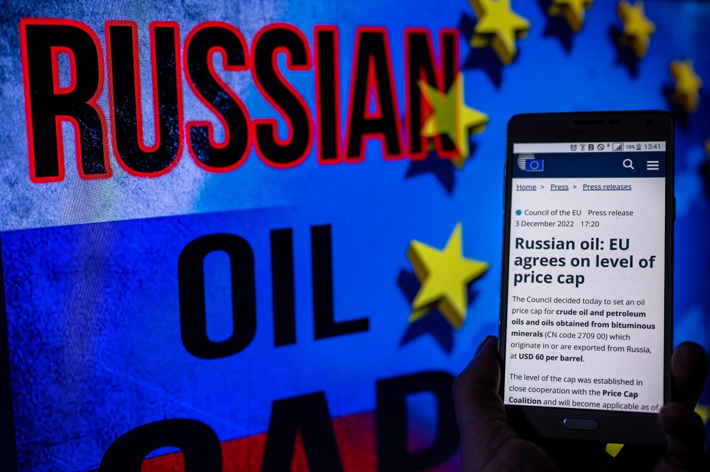 EU logo with Russian flag on screen with EU Commission press release on mobile