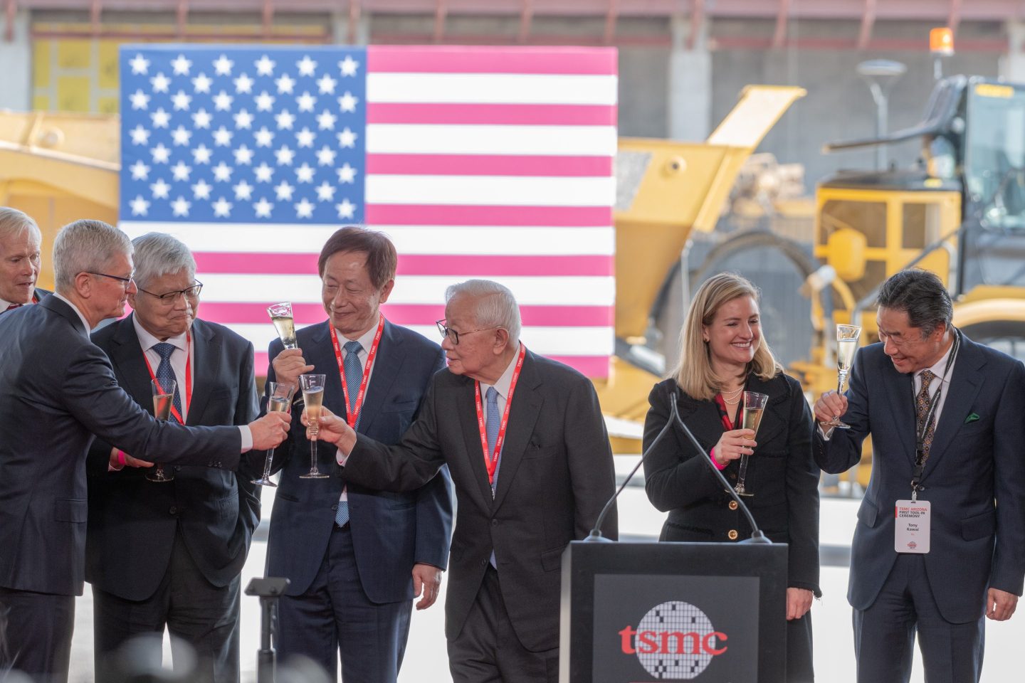 TSMC founder Morris Chang toasts Apple CEO Tim Cook at an Arizona press conference with a U.S. flag behind them