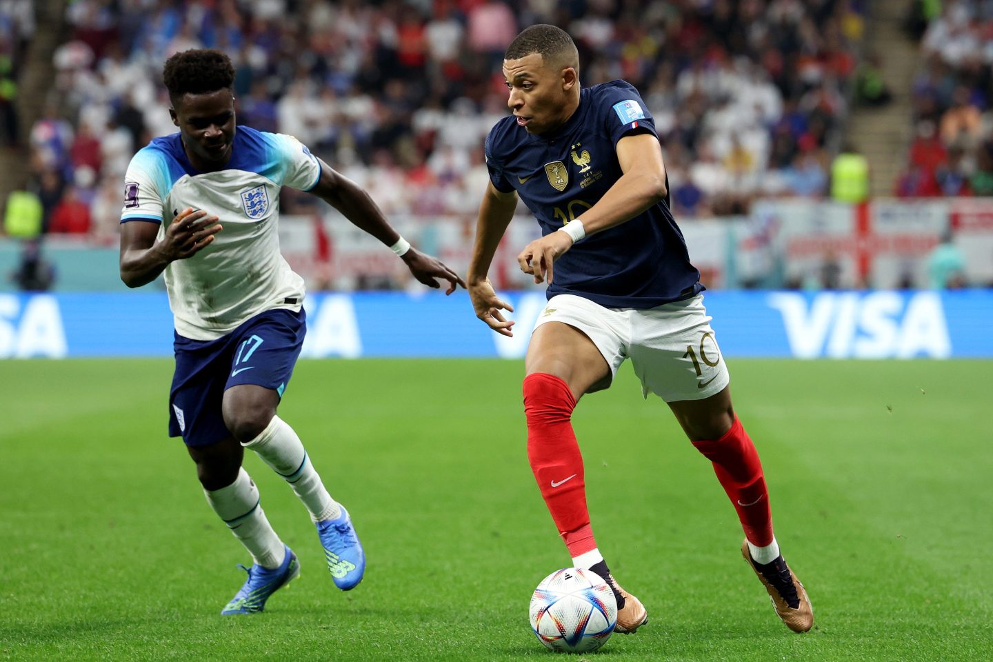 Bukayo Saka of England tries to tackle Kylian Mbappe of France during the FIFA World Cup Qatar 2022 quarter final match.