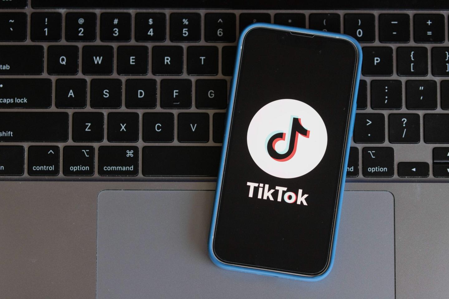 photo illustration, a TikTok App Logo is displayed on a mobile phone
